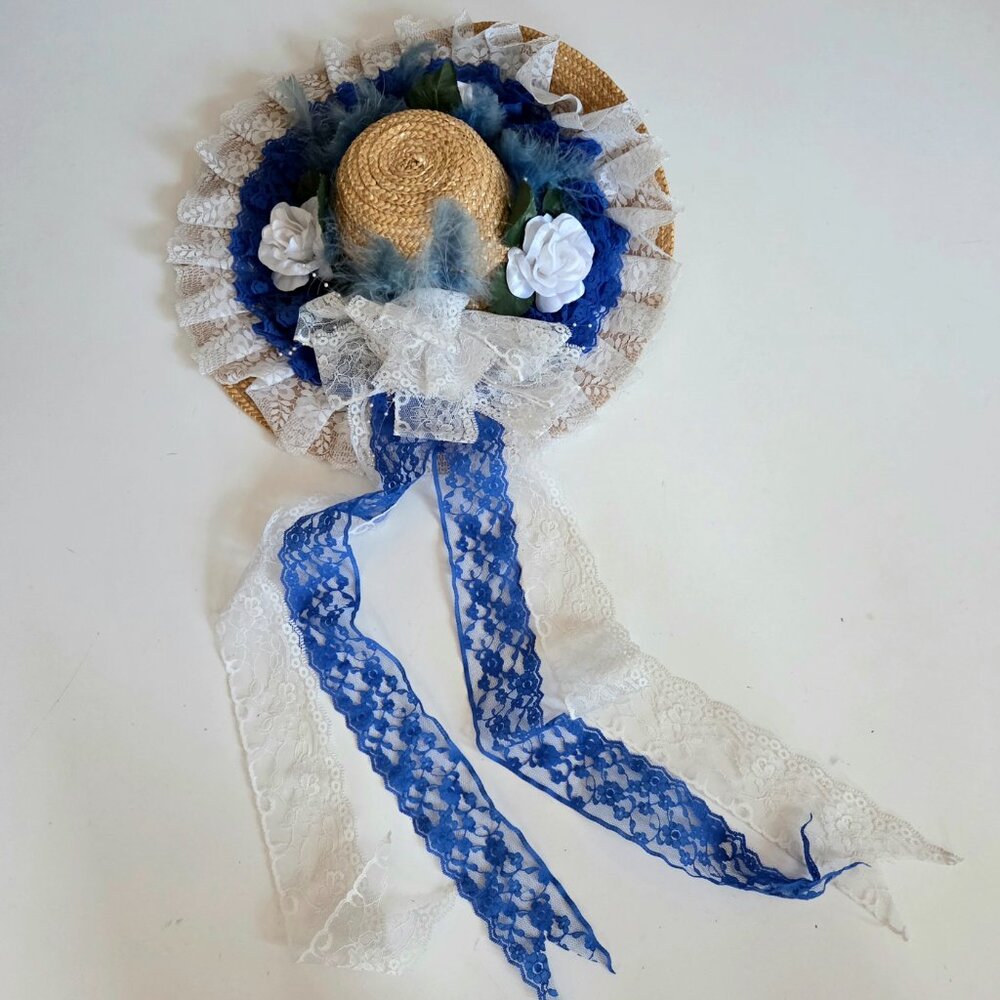 Romantic style decorative straw hat w blue and white ribbons and floral design.